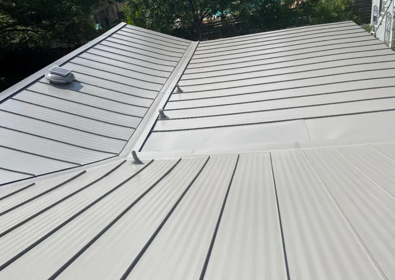 Solar attic fan installed on a metal roof for Roof Ventilation in Manchester-by-the-Sea
